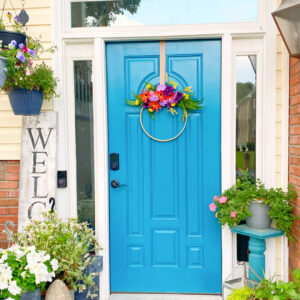 thrift and dollar store diy spring wreath on the teal door